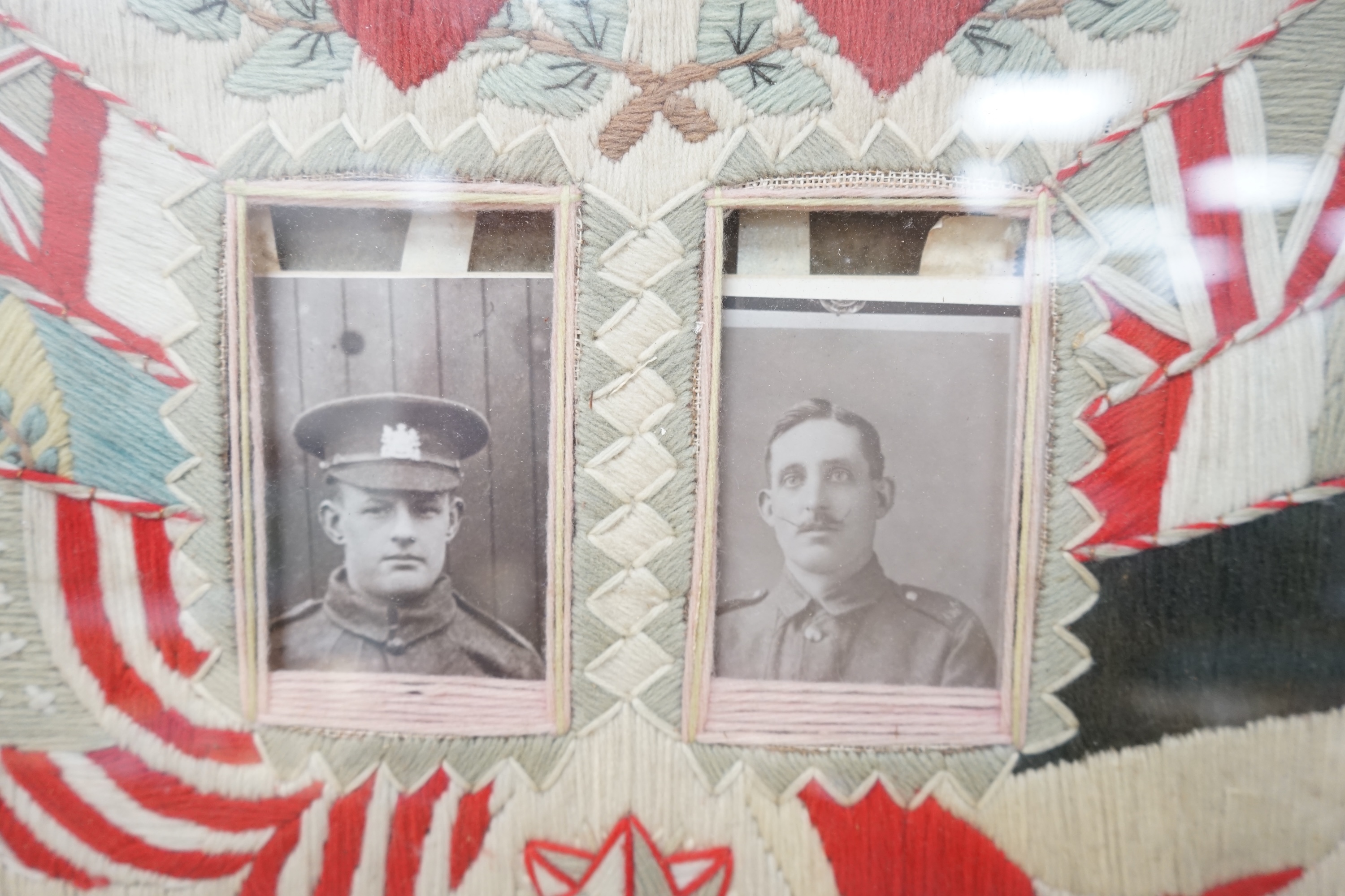 Two early 20th century woolwork panels housing black and white photographs to include soldiers in military dress, maple framed, 42 x 52cm. Condition - fair